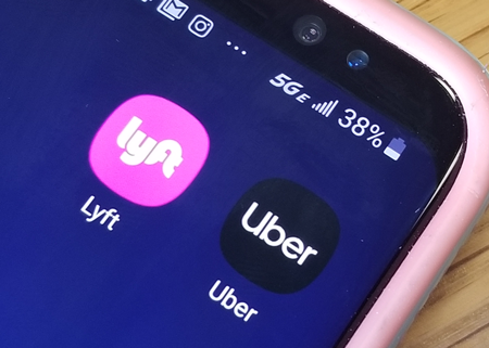 Photo of Lyft and Uber app icons on a mobile device.