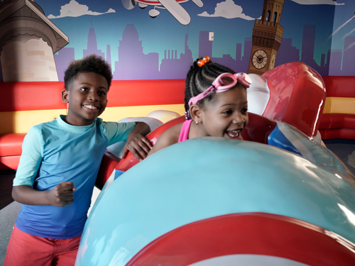 Photograph of siblings enjoying the D/E Children's Play Area at BWI Marshall Airport.