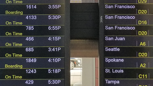 Flight boards show arrivals and departures at BWI Marshall Airport.