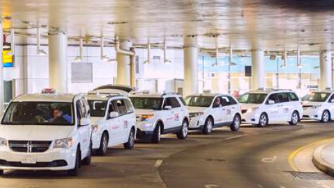 Photograph of taxis in line on terminal drive in front of BWI Marshall Airport.
