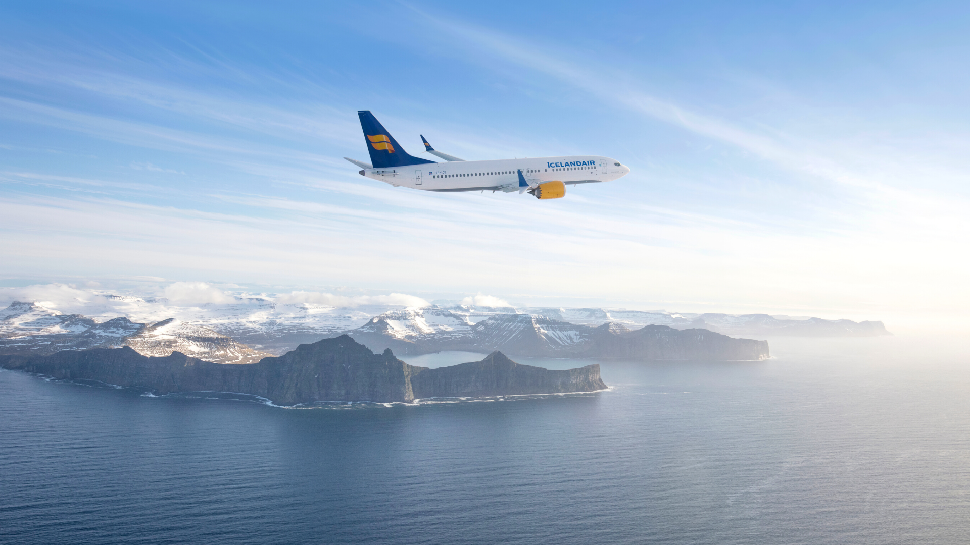 Photograph of Icelandair Max 8 aircraft flying over Iceland