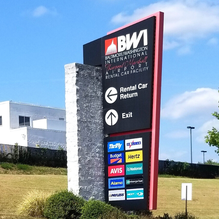 Photograph of roadside sign listing various rental car companies at BWI Marshall Airport Rental Car Facility.