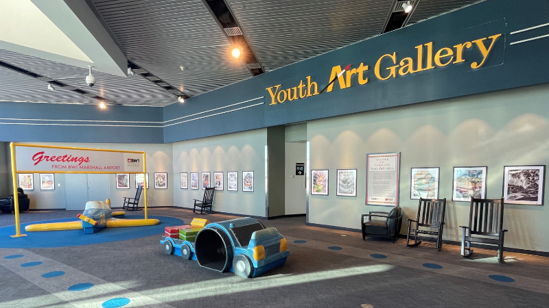 Photograph of most of the works displayed in the Youth Art Gallery exhibit at BWI Marshall Airport