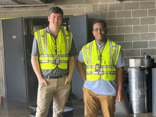 Photo of two Maryland Aviation Administration interns wearing high visibility vests while on the job at BWI Marshall Airport.