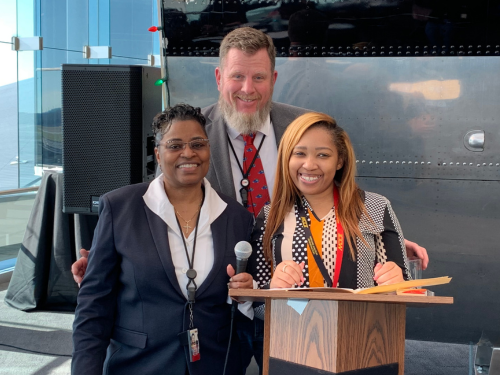 Photo of 3 Maryland Aviation Administration employees posing for a photo during an employee recognition event at BWI Marshall Airport.