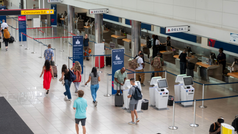 Overhead photo showing passengers walking past the Delta Air Lines ticketing counters at BWI Marshall Airport.