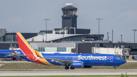 Photo of a Southwest Airlines aircraft on a taxiway at BWI Marshall Airport with the airport's terminal building and control tower in the background.