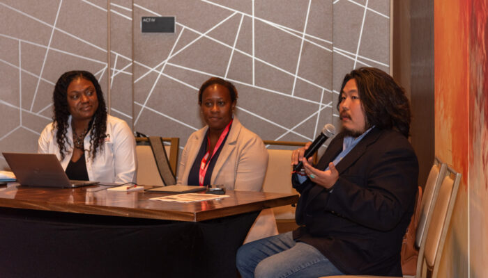 Photo of three panelists, one of them speaking, during a breakout session at the 2024 SynergyBWI Business and Networking Event.