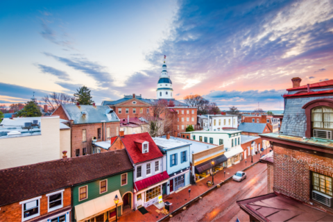 Photo overlooking storefronts in Annapolis, Maryland with the Maryland State House in the background