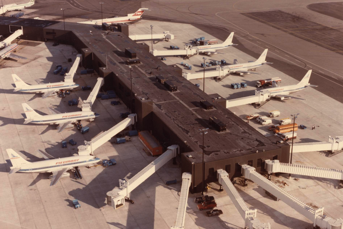 Aerial photo showing multiple Piedmont Airlines aircraft parked at gates at BWI Airport, circa late 1980s.