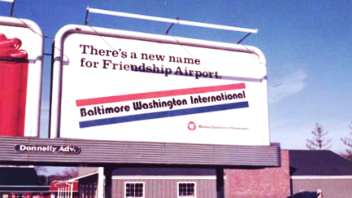 Photo of a billboard noting the name change of Friendship to Baltimore Washington International Airport, circa 1973.