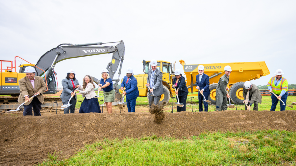 Photo of 11 individuals participating in a groundbreaking ceremony for a new air traffic control tower at Martin State Airport.