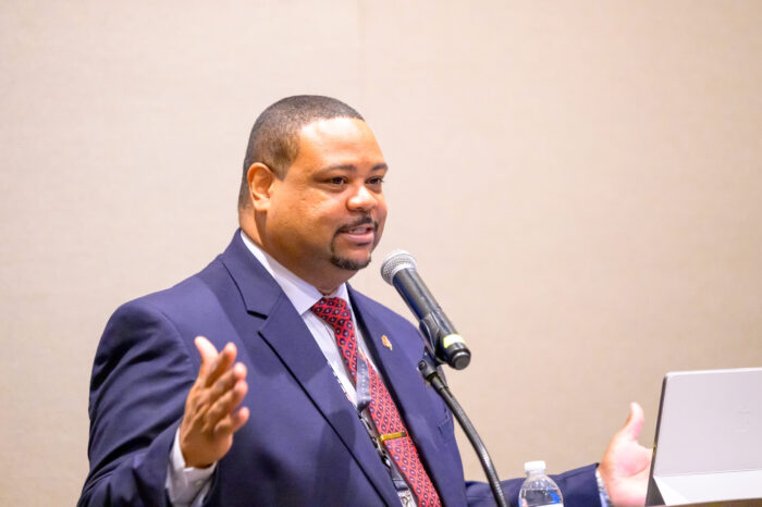 Photo of a panel moderator speaking during a breakout session at the 2025 SynergyBWI Business and Networking event.