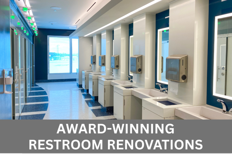 Interior photo of a renovated, award-winning restroom at BWI Thurgood Marshall Airport with overlay of following white text on grey background along the bottom of the image. Awarding-winning restroom renovations.