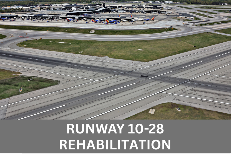 Aerial photo of the intersection of Runways 10-28 and 15R-33L at BWI Thurgood Marshall Airport with overlay of following white text on grey background along the bottom of the image. Runway 10-28 Rehabilitation.